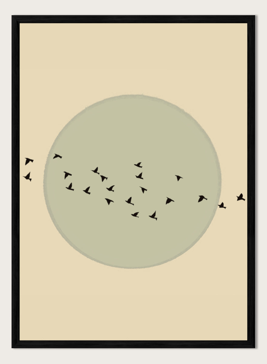 Minimalist art print featuring a large muted sage green circle centered on a warm beige background, with small black bird silhouettes flying around it. Flock Against The Moon by The Art Concept is a minimalist bird art print featuring black birds in flight across a pale green moon and warm cream background.