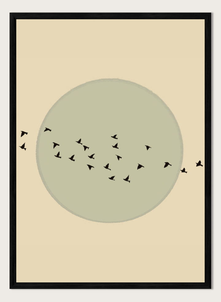 Minimalist art print featuring a large muted sage green circle centered on a warm beige background, with small black bird silhouettes flying around it. Flock Against The Moon by The Art Concept is a minimalist bird art print featuring black birds in flight across a pale green moon and warm cream background.