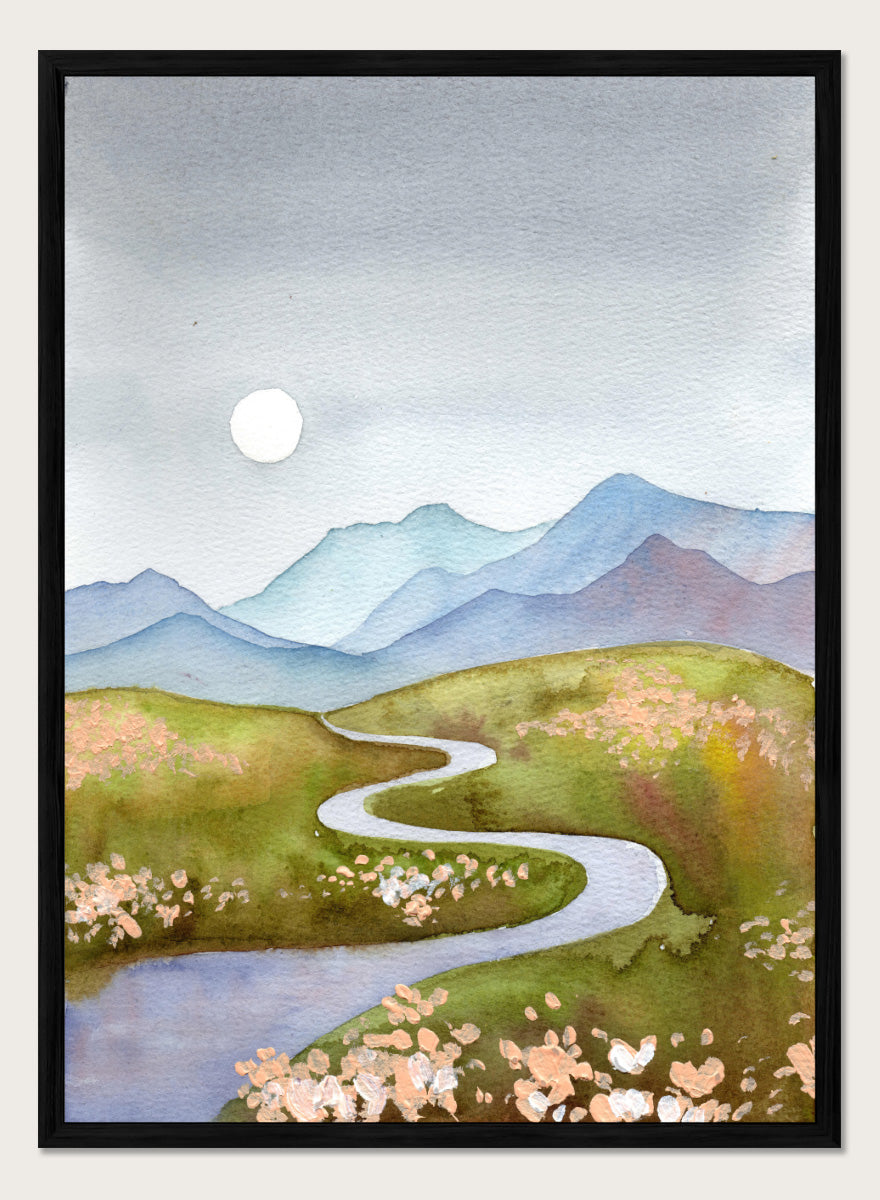 Watercolor landscape painting of a winding river flowing through green hills with pink flowers, blue mountains in the background, and a white sun in a gray sky. Shop Serene Mountain Path by Ekaterina Prisich, a landscape art print featuring a winding valley path, blue mountains, soft flowers, and a white moon.