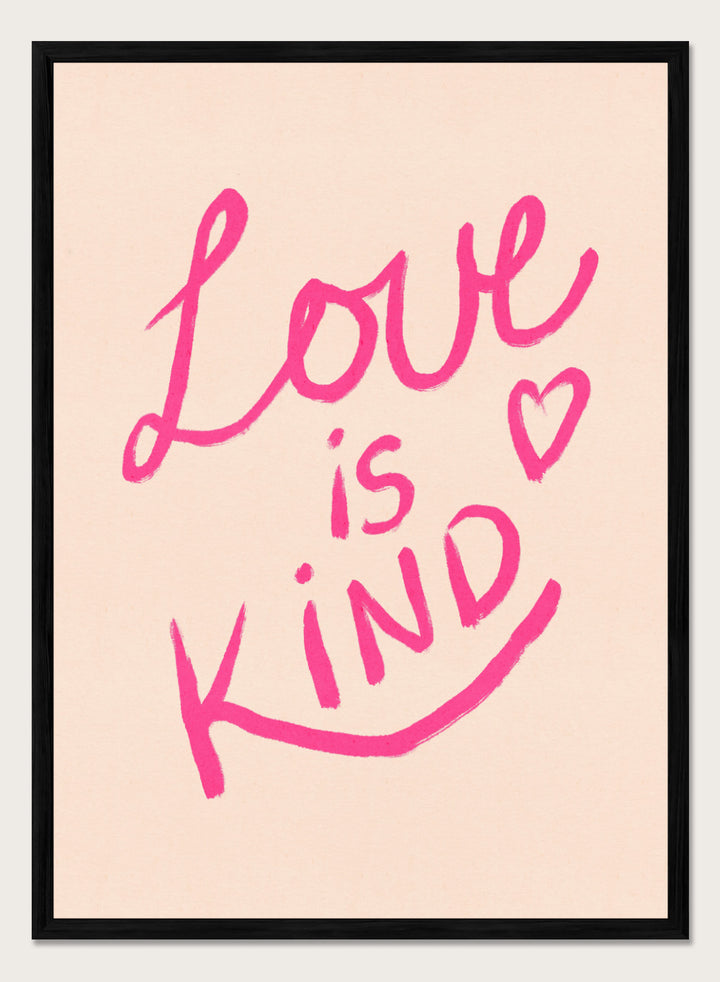 Pink text 'Love is Kind' with a heart on a light pink background. Love Is Kind by Dirkie Nell is a pink typography art print with handwritten lettering and heart detail. A joyful modern love wall poster.