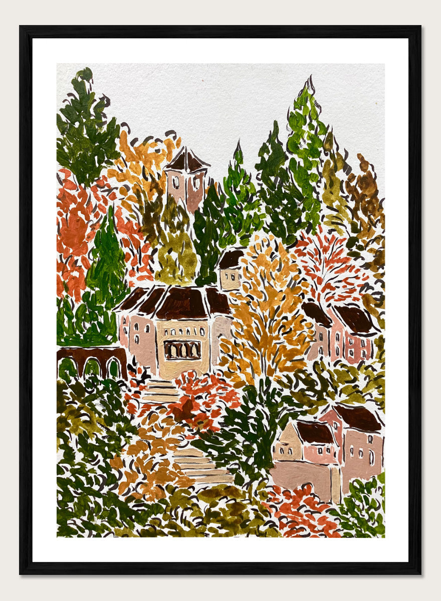 A framed art print featuring a hand-drawn, stylized landscape of a hillside village with beige buildings, brown roofs, and dense trees in green, yellow, orange, and red tones. Shop Autumn Hillside Village by Rushati Chowdhury, a colorful autumn landscape art print with hillside homes, winding steps, dense trees, and warm fall tones.