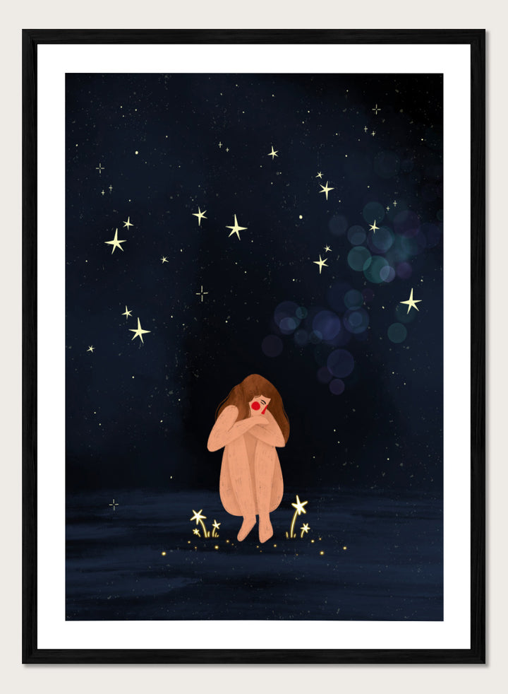 A framed art print featuring a whimsical illustration of a girl sitting on a dark blue starry night sky. Shop Starlit Solitude by Bea Müller, a figurative wall art print poster featuring a solitary woman beneath a star-filled night sky in deep blue tones.