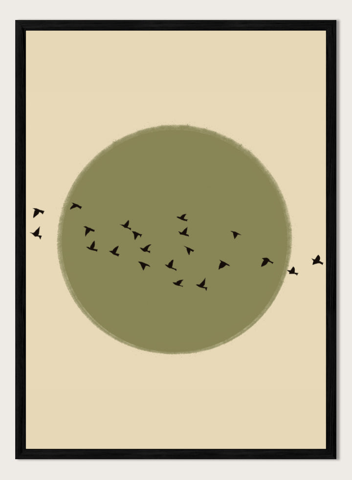 Minimalist art print featuring a large olive green circle with small black bird silhouettes flying across it, set against a warm beige background. Graceful Birds Soaring by The Art Concept is a minimalist bird art print featuring black birds in flight across an olive green circle and warm cream background.