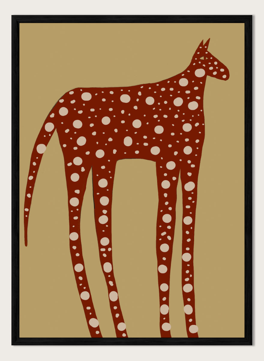 A stylized art print of a giraffe in reddish-brown with white spots, set against a tan background. Spotted Earthy Creature by The Art Concept animal art print featuring a long-legged rust-colored figure with cream spots on a muted tan background.
