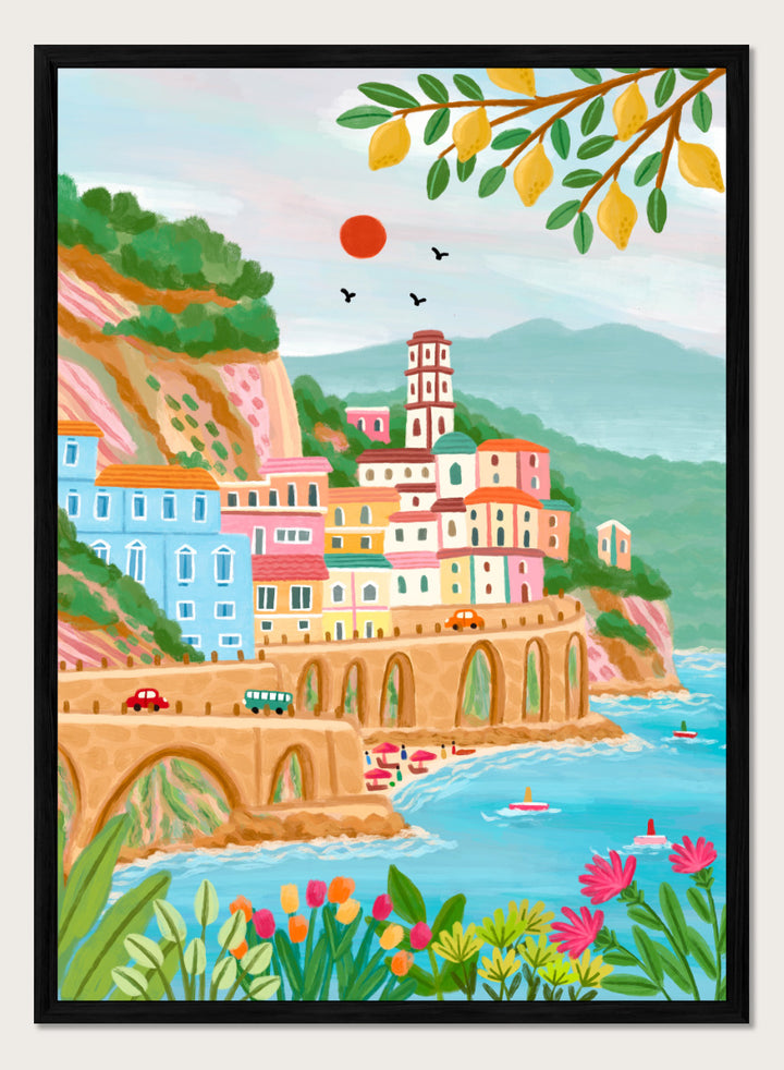 A colorful illustrated coastal town scene with pastel buildings, a stone bridge, blue water, mountains, flowers, and hanging yellow leaves. Shop Colorful Amalfi Coast by Nidhi Kachhadiya, a vibrant Italian coastal wall art print inspired by the Amalfi Coast, pastel villages, blue sea, and lemon trees.